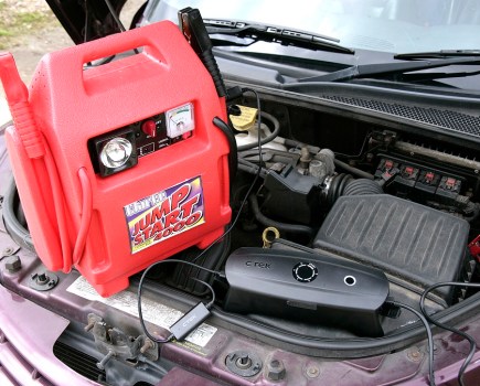 CTEK CSFree Battery Charger resting in a car's engine bay.