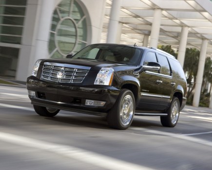 Cadillac Escalade driving through street.