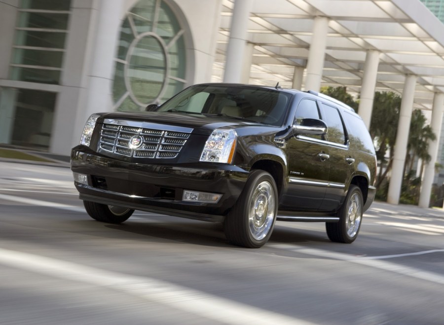 Cadillac Escalade driving through street.