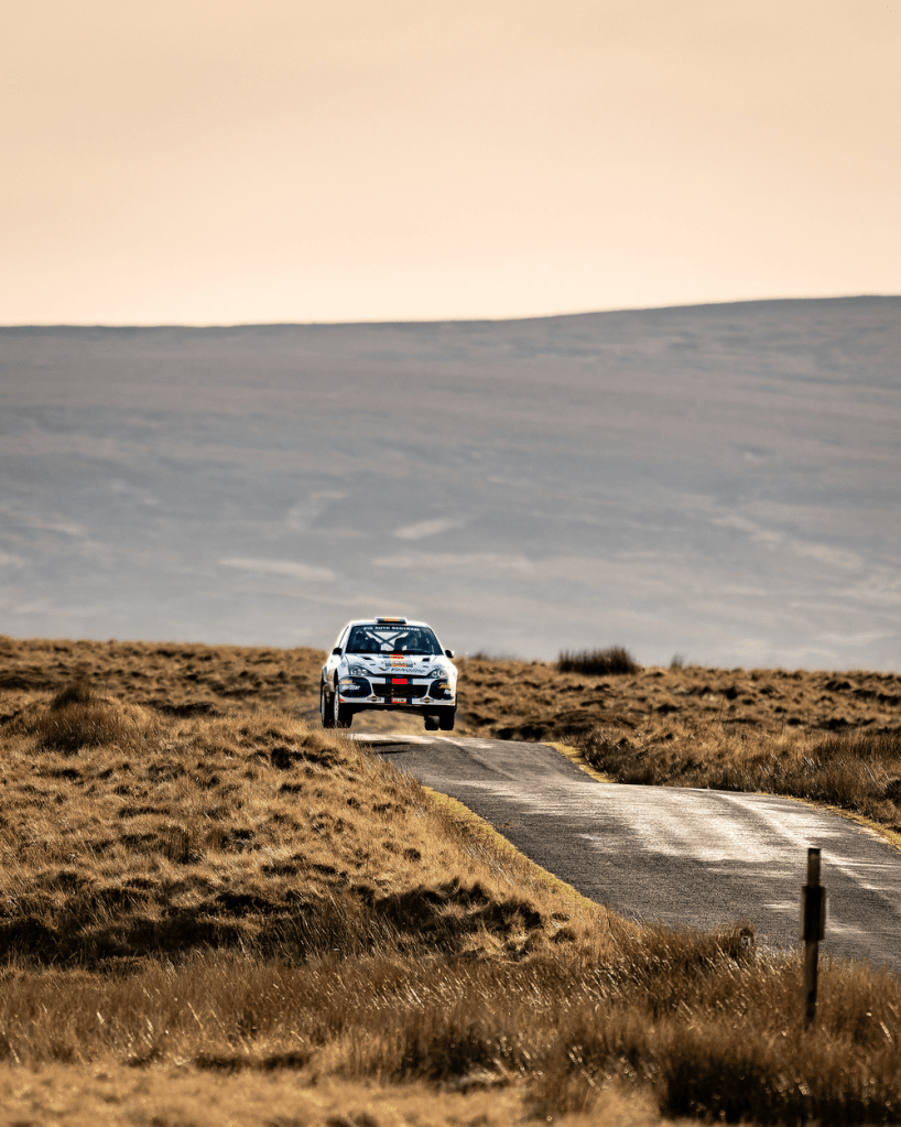 Focus WRC driving over a crest in the road