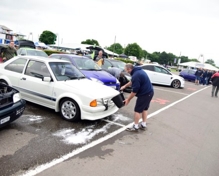 Man cleaning a car at a car show