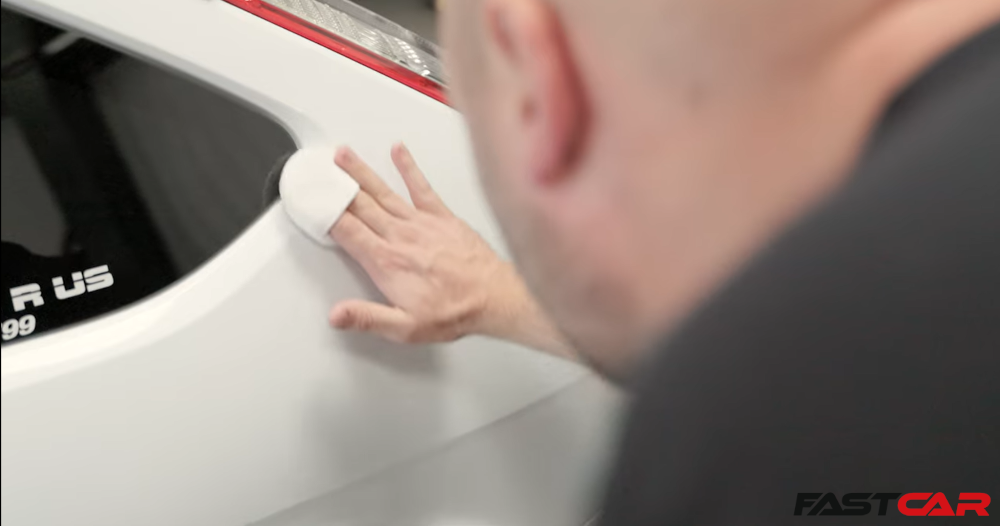 man applying ceramic coating to a car