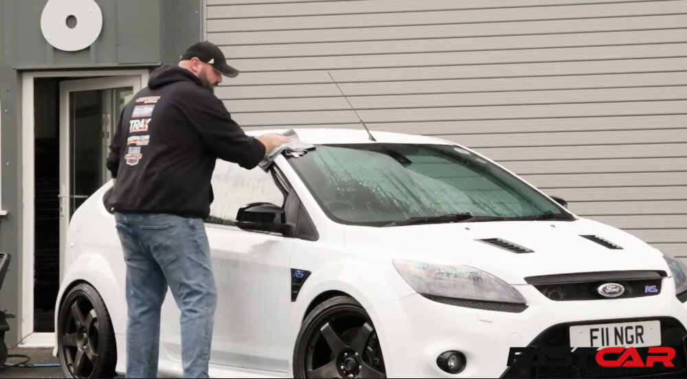 man drying car after washing it